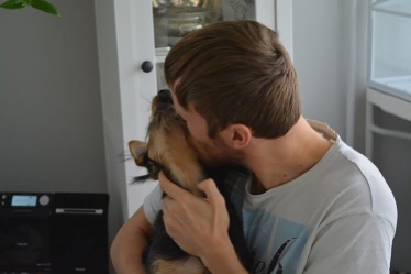 Adopted dog surrounded by the love of her new owner 