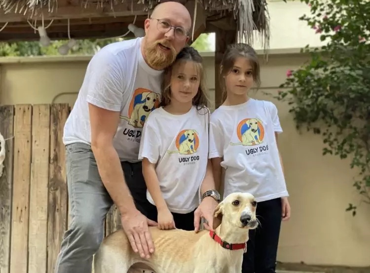 Adopted dog with his loving family