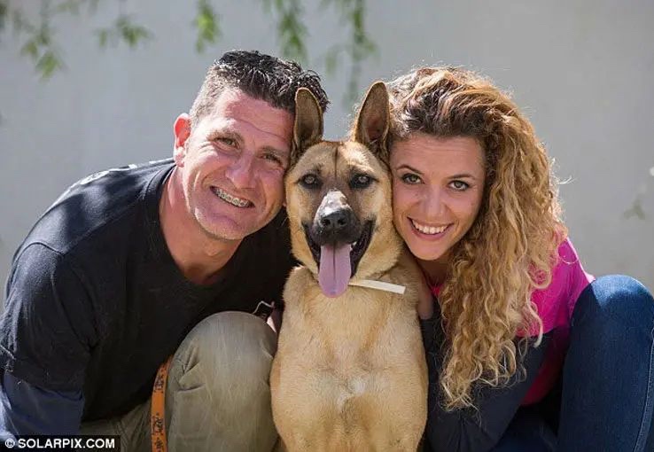 Happy adopted dog with her new family